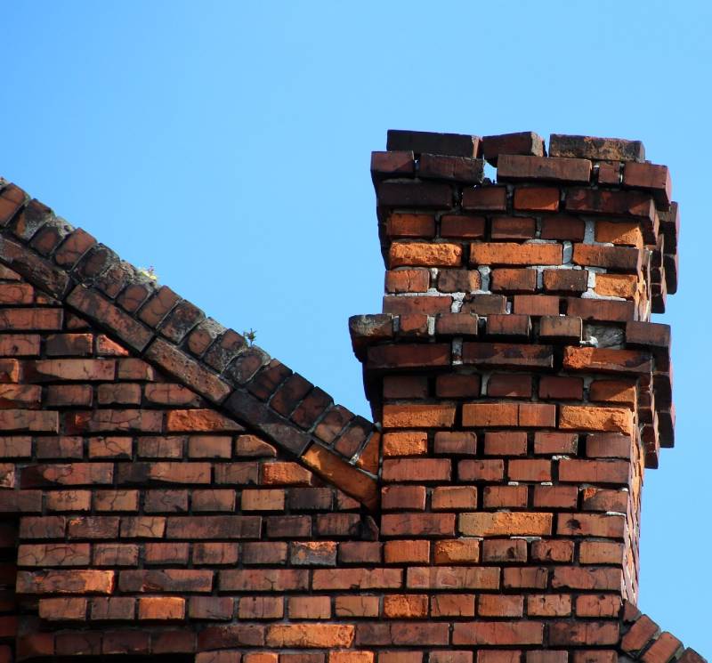 Signs Your Billerica Home Needs a Chimney Inspection Damaged chimney on an Billerica home showing cracks and missing mortar